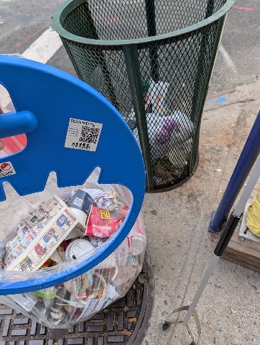 A trash can next to another full public bin during a litter patrol